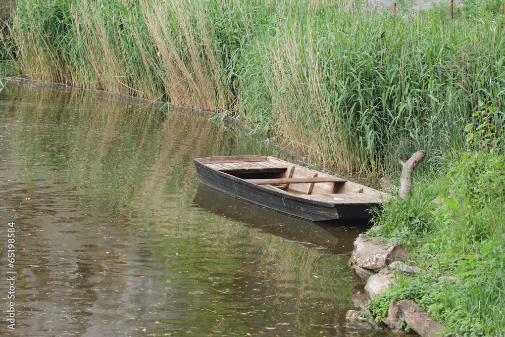 Pond and wooden flat-bottomed boat