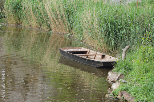 Pond and wooden flat-bottomed boat