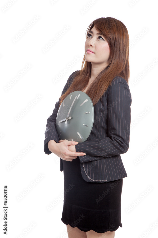 Asian Businesswoman hold a clock thinking of something Asian Businesswoman hold a clock thinking of something
