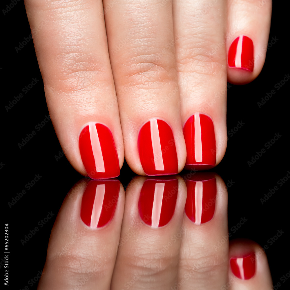 Woman hands with manicured red nails closeup