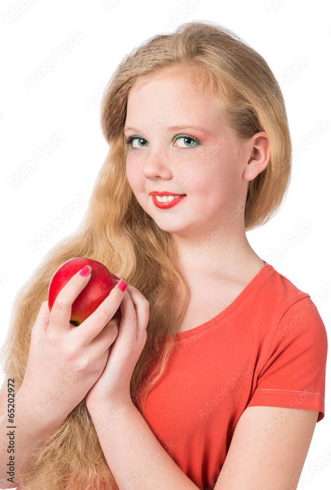 Attractive teen girl in the orange t-shirt holding an red apple