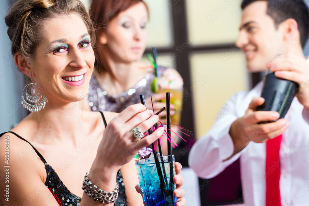 Woman drinking cocktails in cocktail bar