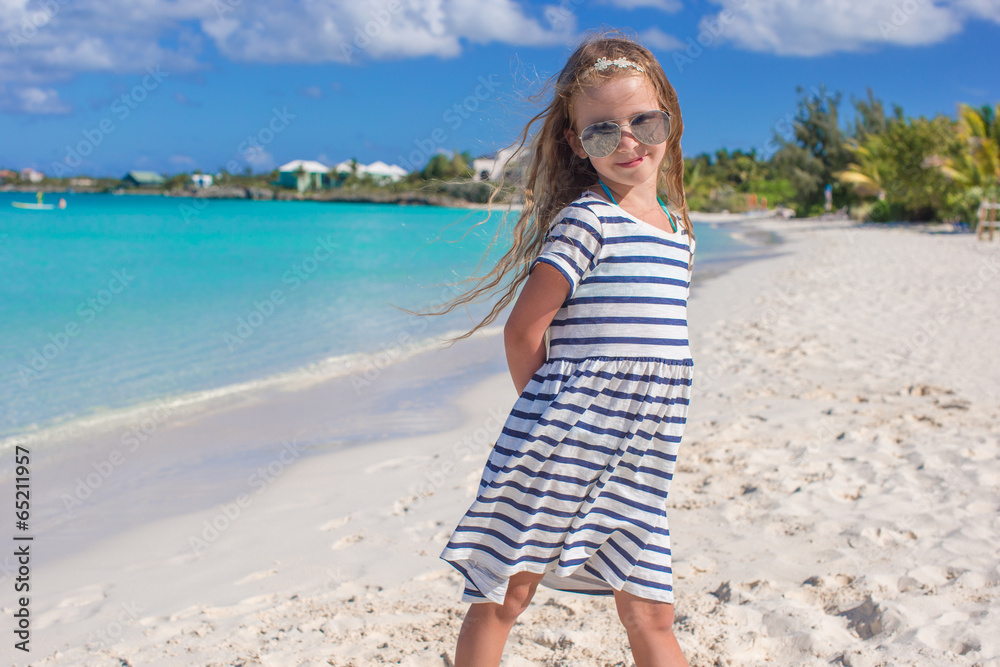 Adorable little girl at beach during summer vacation Adorable little girl at beach during summer vacation