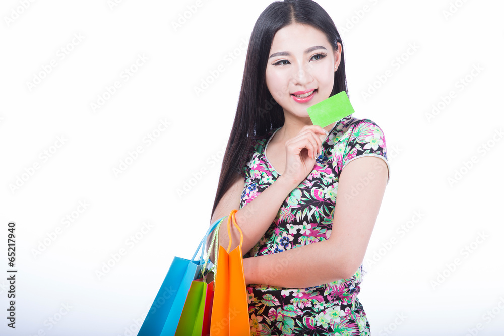 young woman with shopping bags and credit card on a white backgr young woman with shopping bags and credit card on a white backgr
