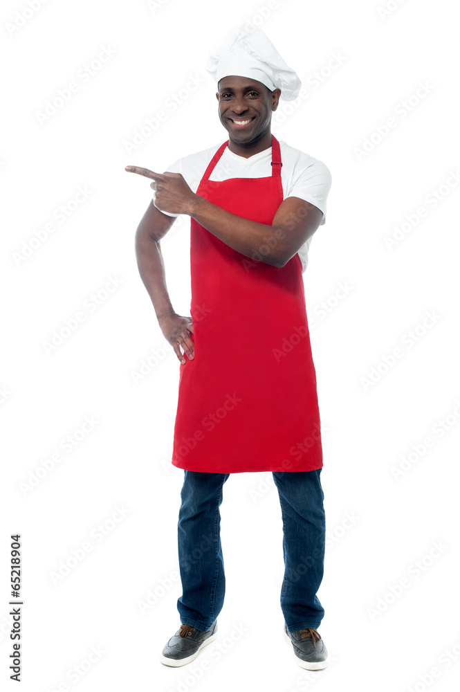 Handsome male chef showing menu Handsome male chef showing menu
