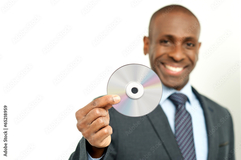 Handsome businessman holding a cd