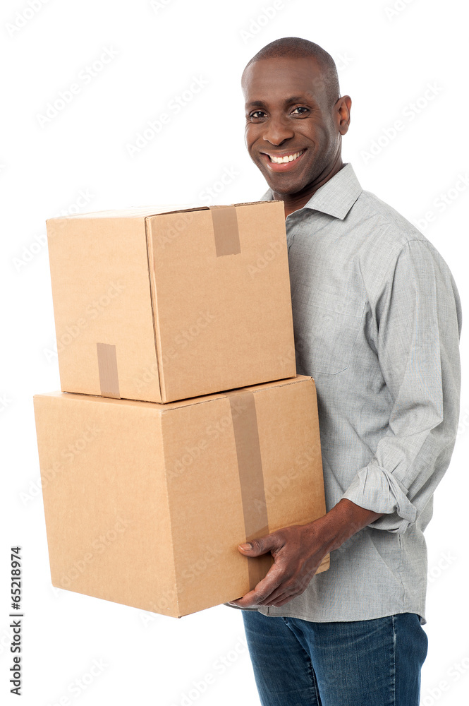 Smiling man holding cardboard boxes Smiling man holding cardboard boxes