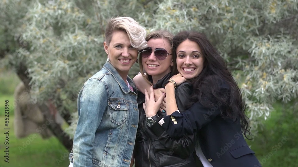 Three beautiful women girlfriends posing on camera Three beautiful women girlfriends posing on camera