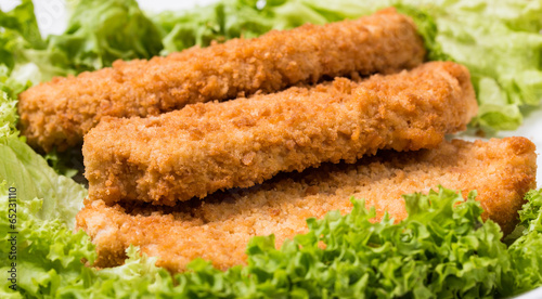 Fried battered chicken breast fillet  with lettuce on the plate