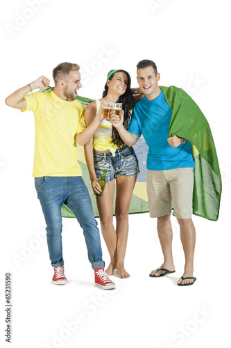 young group of brazil supporters cheering with Brazil flag