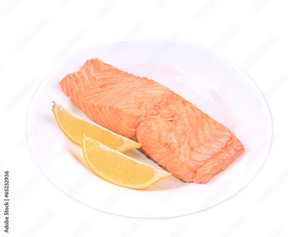 Fried salmon fillet on plate with lemon. Fried salmon fillet on plate with lemon.