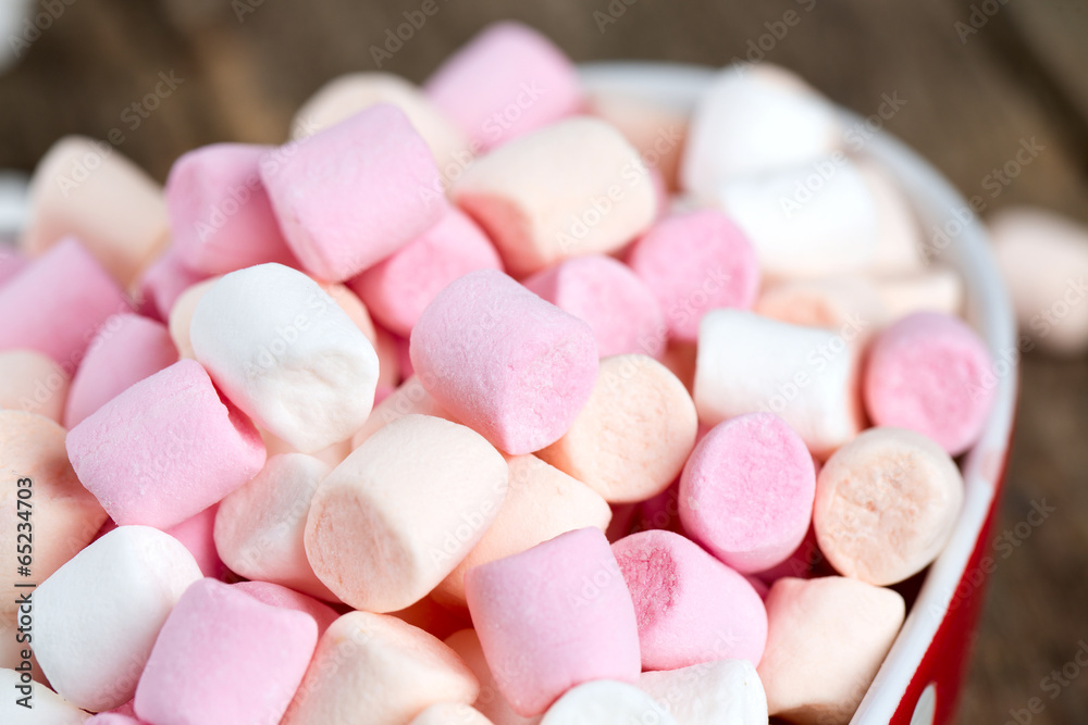 marshmallows in heart shape bowl on a wooden table marshmallows in heart shape bowl on a wooden table