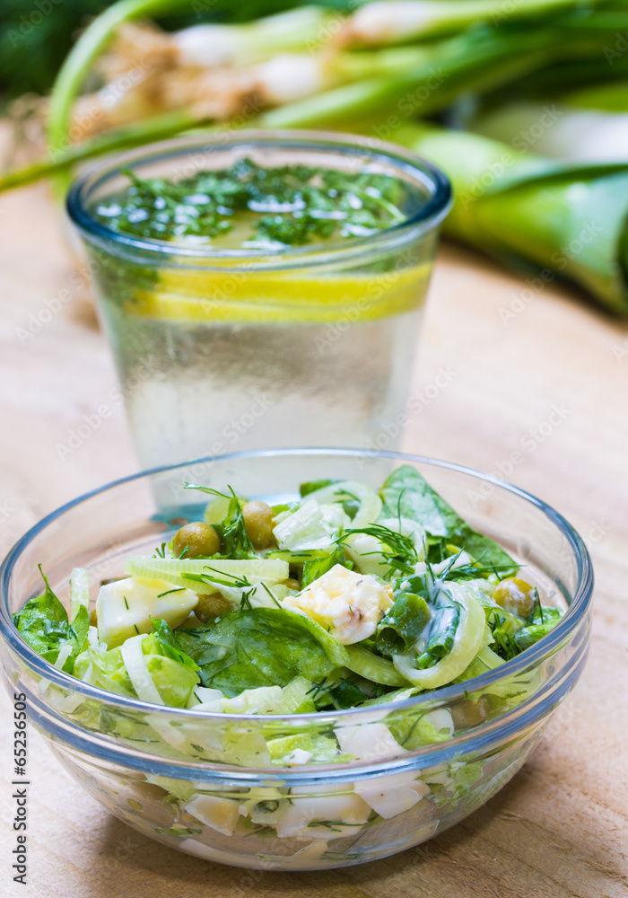lemonade with parsley and bowl of vegetarian salad lemonade with parsley and bowl of vegetarian salad