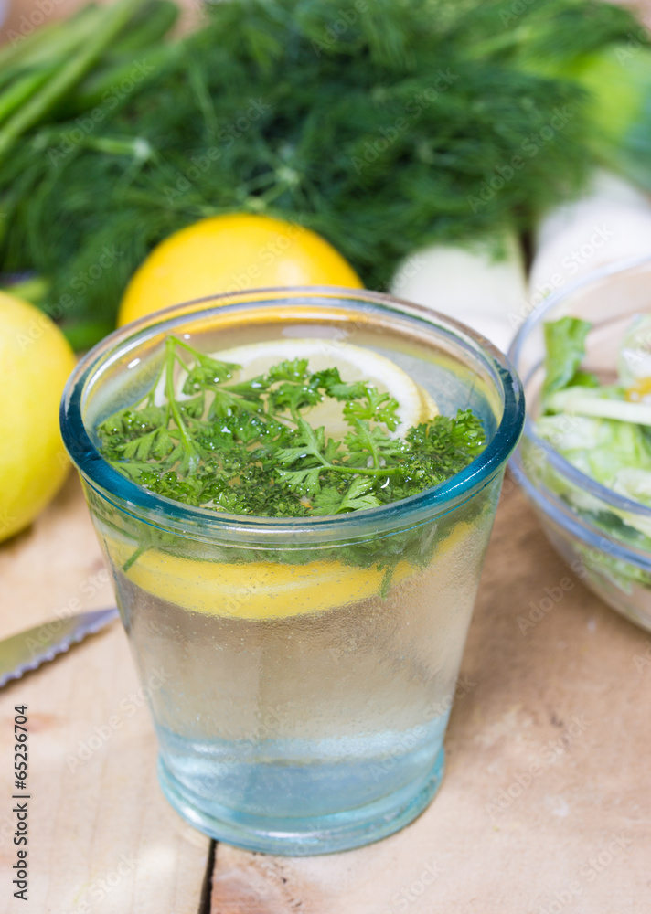 Fototapeta premium glass of fresh detoxing lemonade with parsley