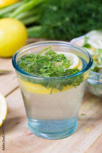 glass of fresh detoxing lemonade with parsley