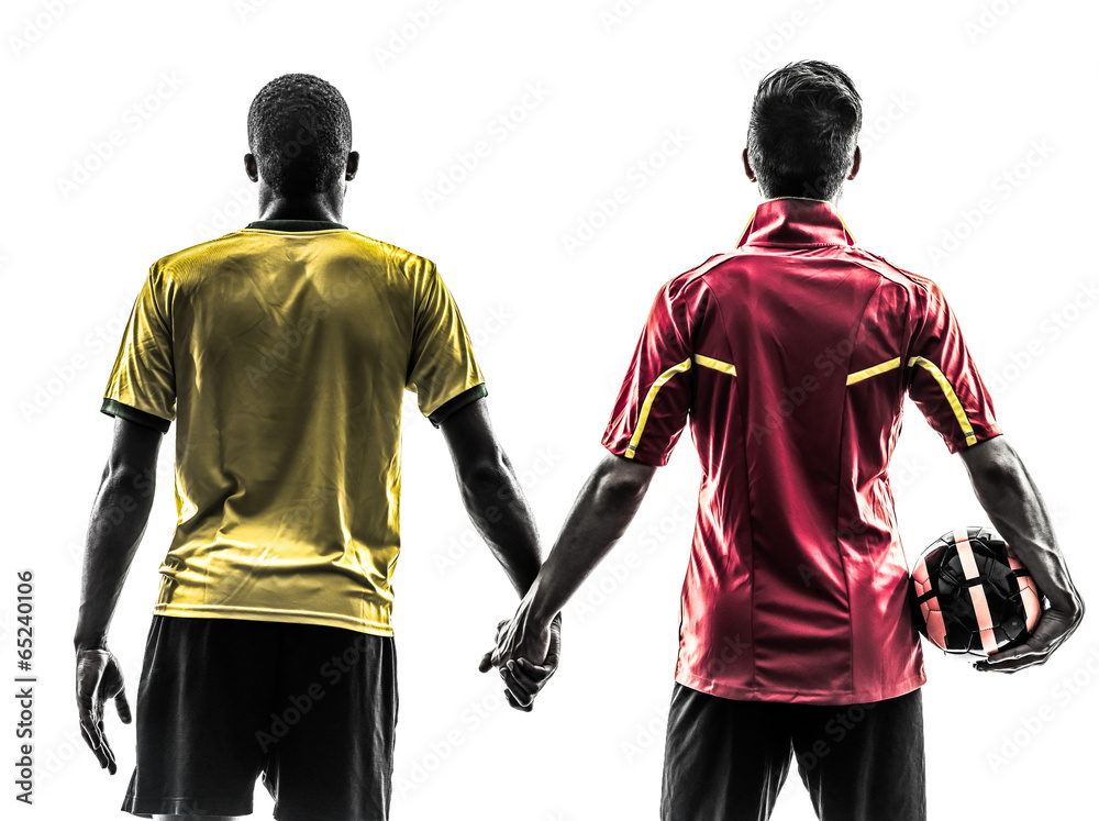 Fototapeta premium two men soccer player standing holding hands silhouette