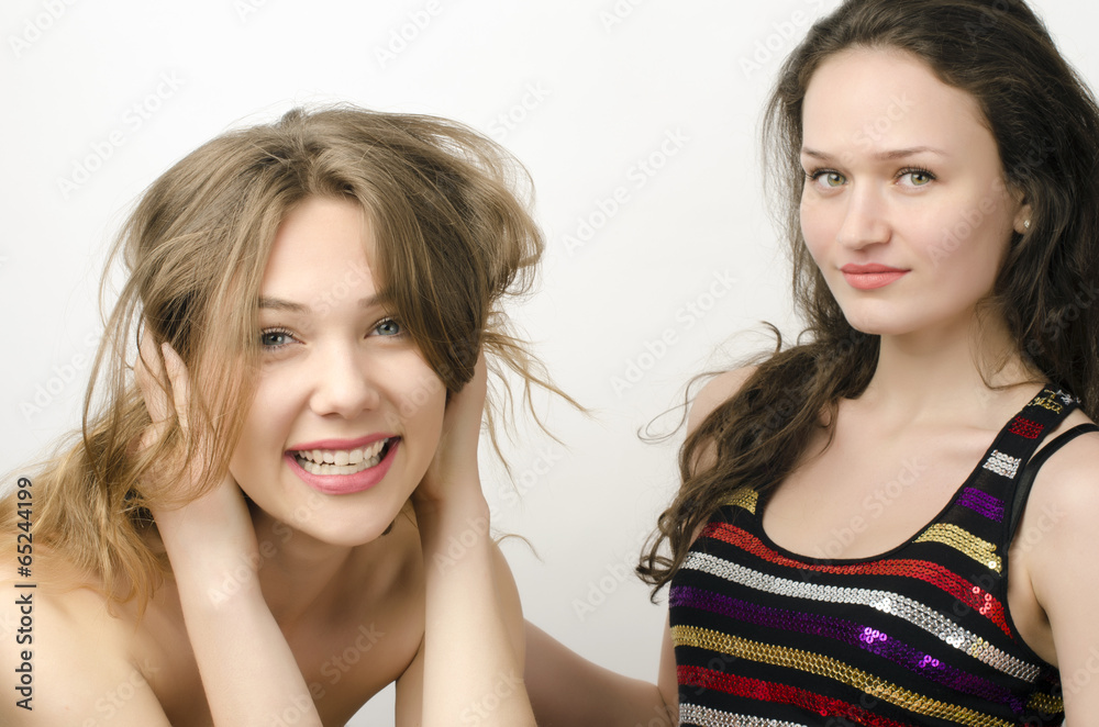 Two beautiful women, one brunette and one blonde posing fashion Two beautiful women, one brunette and one blonde posing fashion