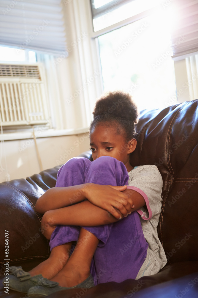 Unhappy Girl Sitting On Sofa At Home Unhappy Girl Sitting On Sofa At Home