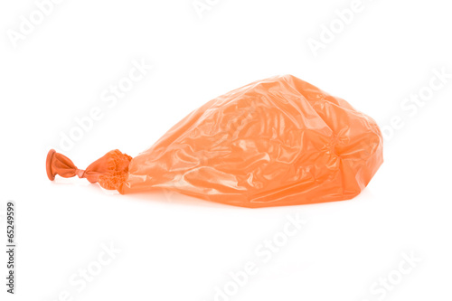 Tableau sur toile Deflated orange balloon isolated over white
