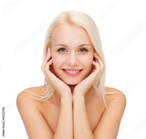 face of beautiful woman touching her face skin