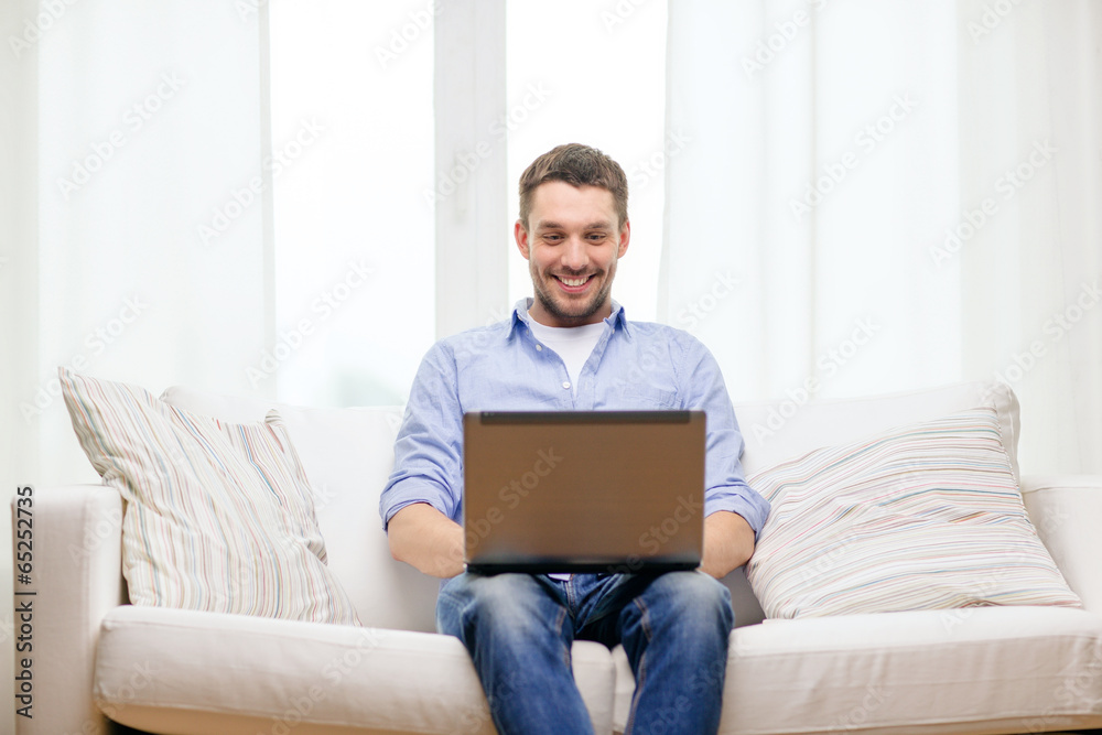 smiling man working with laptop at home smiling man working with laptop at home