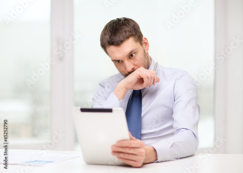 stressed businessman with tablet pc and documents