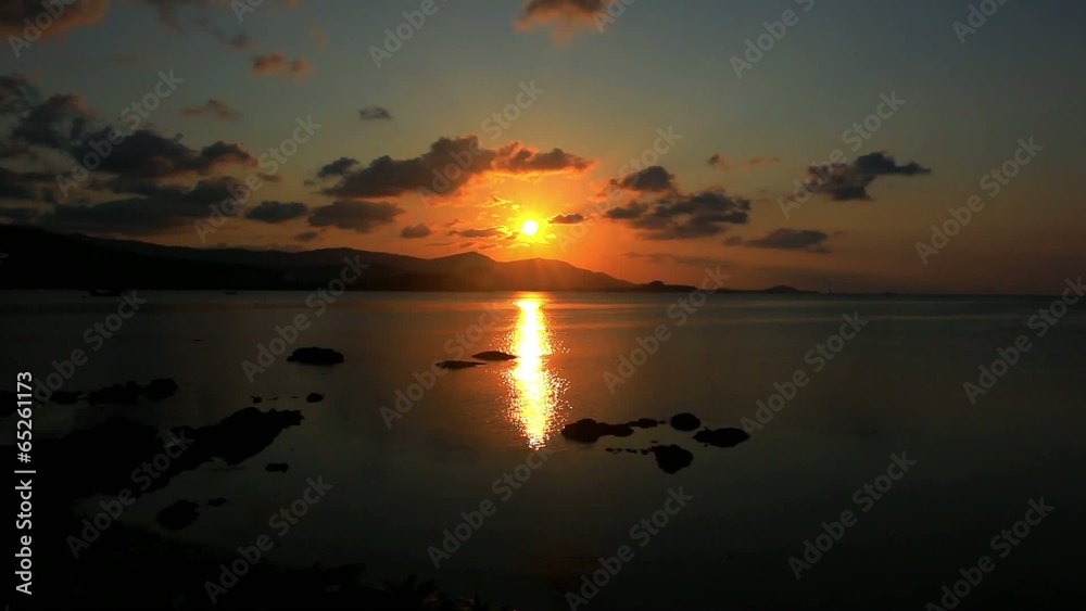 Sunset at sea, mountains in background and mooving ship Sunset at sea, mountains in background and mooving ship