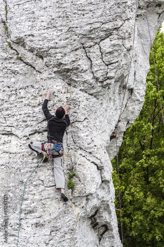  Man climbing limestone wall in Poland.
