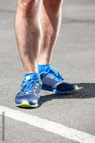 Closeup of a male runner standing - Fitness concept. © Dmytro Panchenko