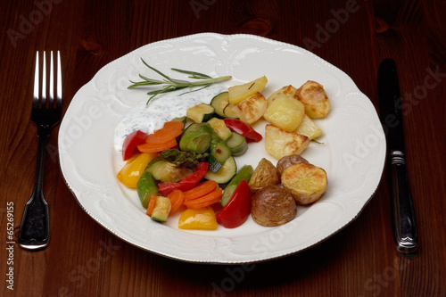 plate with vegetables and oven potatoes