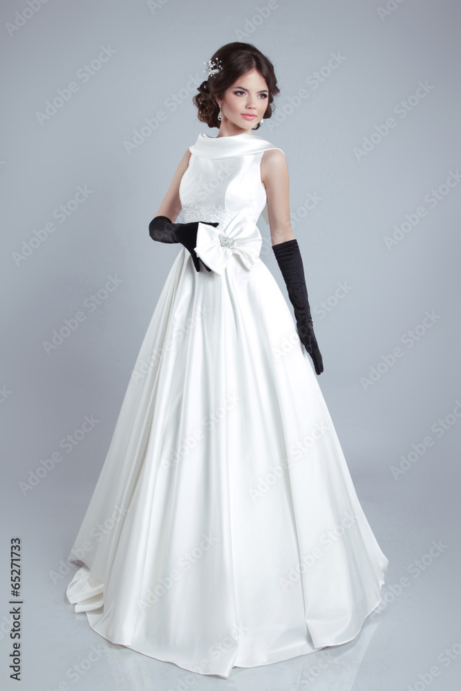 Beautiful young bride woman posing in wedding dress isolated on