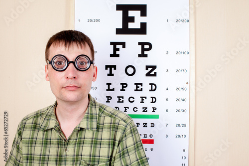 Funny manwearing spectacles in an office at the doctor photo