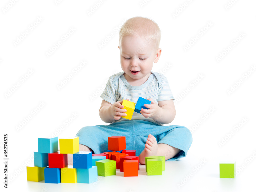 Child boy playing toy blocks isolated on white background Child boy playing toy blocks isolated on white background
