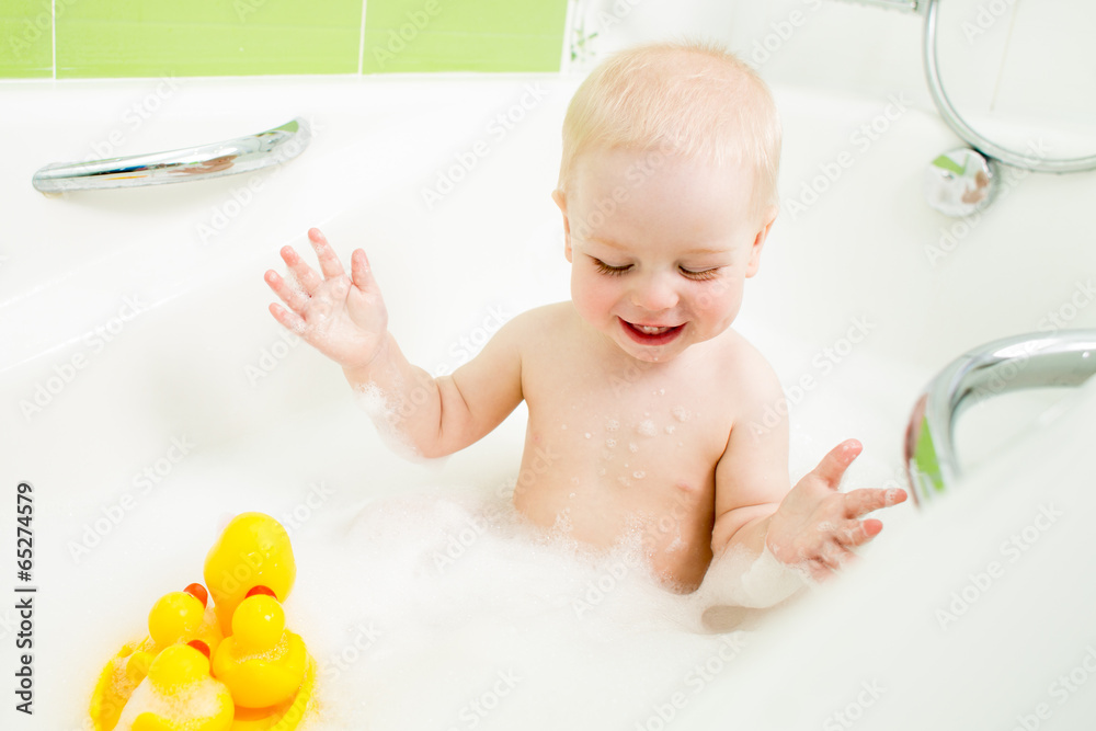 smiling baby boy taking bath and playing with toys smiling baby boy taking bath and playing with toys