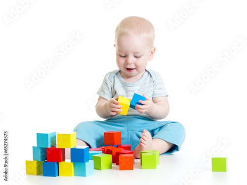 Child boy playing toy block...