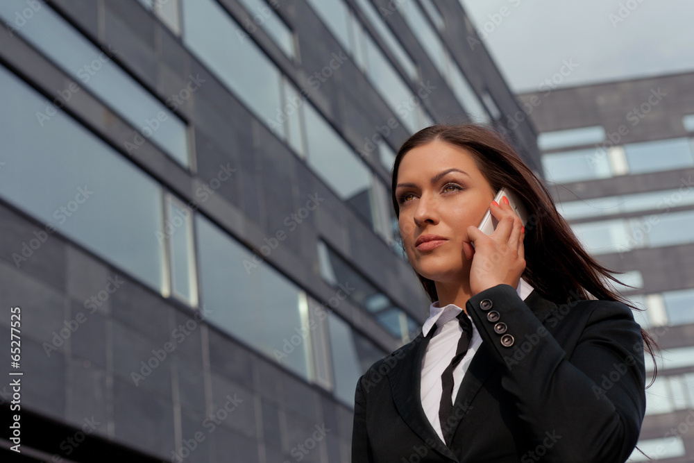 Beautiful business woman on the phone at modern building