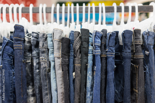 Jeans is hanged on rack.