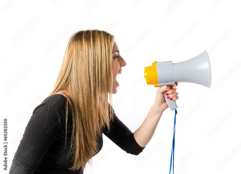 Pretty girl shouting with a megaphone over white background