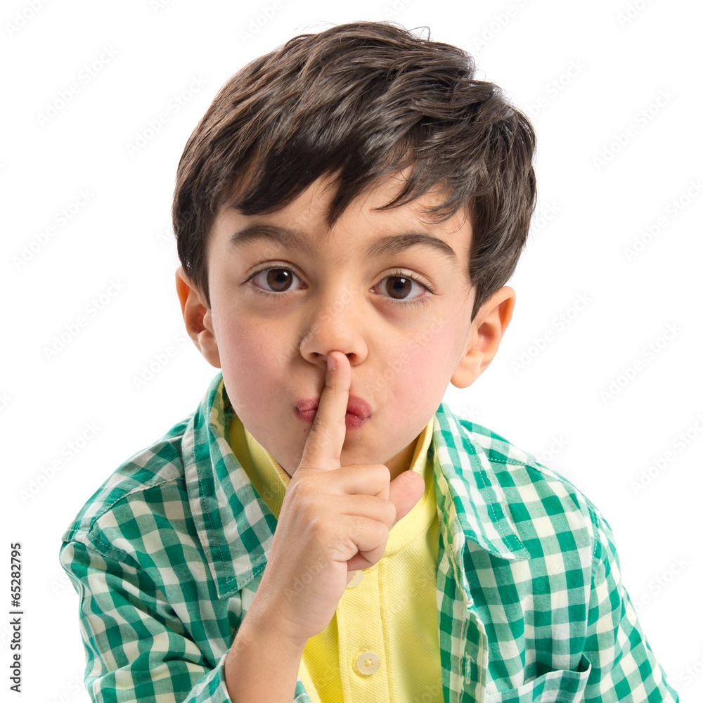Kid doing silence gesture over white background Kid doing silence gesture over white background