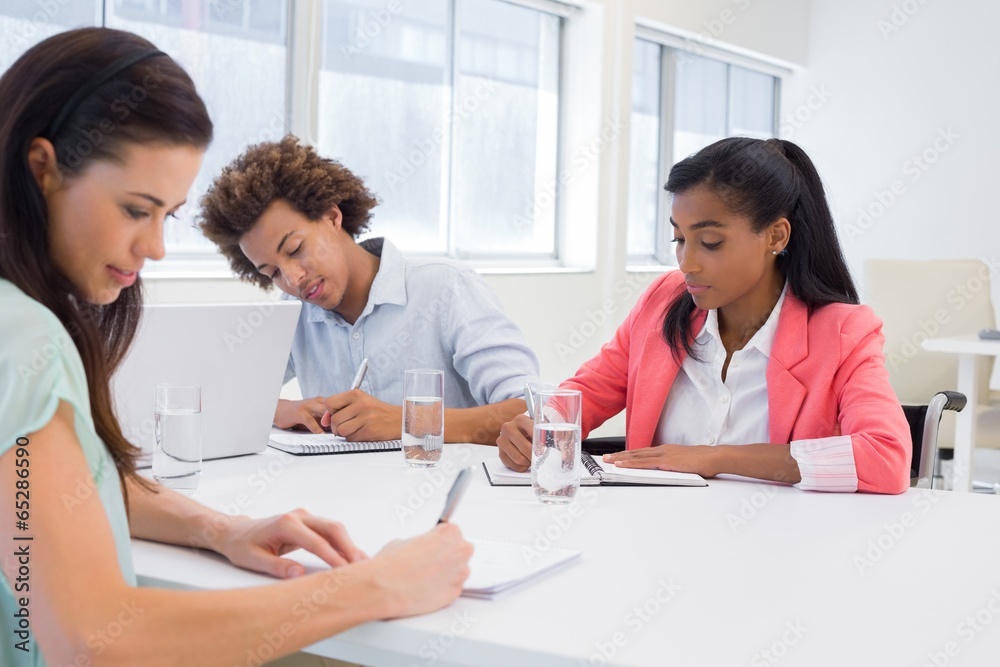 Attractive business people working hard on plans Attractive business people working hard on plans