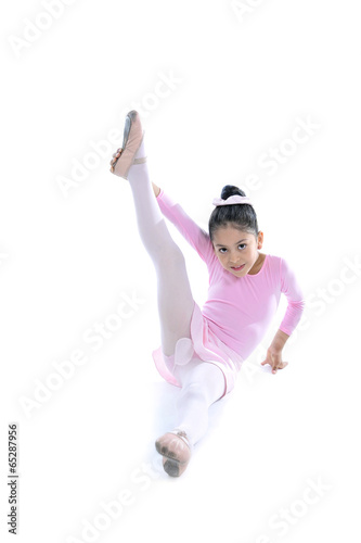Fototapeta Naklejka Na Ścianę i Meble -  young cute Ballerina girl stretching wearing pink Ballet tutu