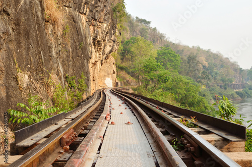 Dead railway beside cliff, along Kwai river in Thailand