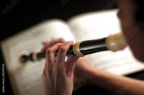 woman who plays the flute focus on fingers