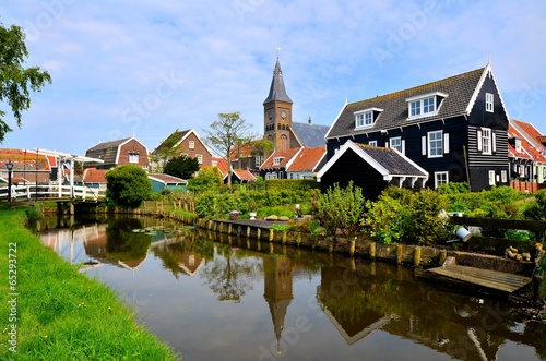 Dutch fishing village of Marken with canal and reflections
