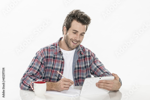 handsome young man using a digital tablet and paper