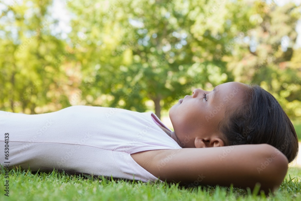 Little girl lying on the grass smiling Little girl lying on the grass smiling