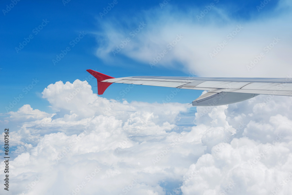 Wing of an airplane flying in the sky Wing of an airplane flying in the sky