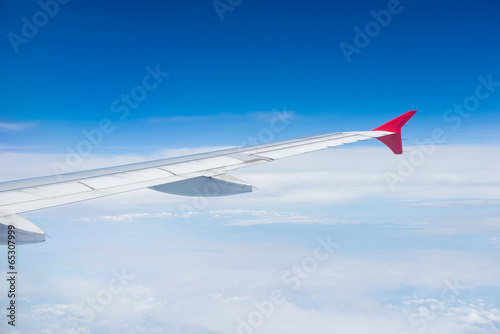 Wing of an airplane flying in the sky