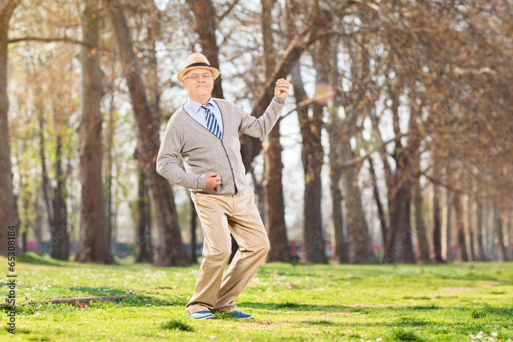 Overjoyed senior playing air guitar outdoors Overjoyed senior playing air guitar outdoors