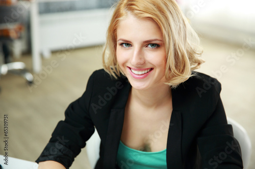 Portrait of a young happy woman in office Free Download Portrait of a young happy woman in office - GFXLoad